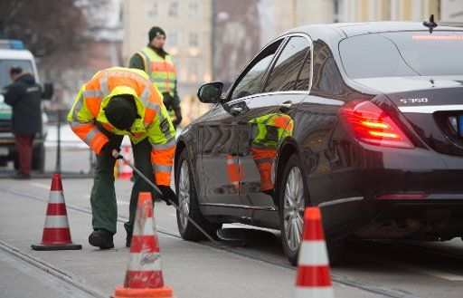 A policeman inspects vehicles near the Bayerischer Hof hotel, before the start of the 51st Munich Security Conference, which will be attended by leaders, foreign minsters and defence ministers, 6 February 2015. PHOTO: TOBIAS HASE\/