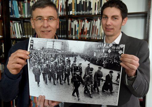 Matthias Sperwien, post employee, and Johannes Rosenplänter, Head of the town archive, hold the famous photo showing the uprising of the sea men in 1918 in Kiel, Germany, 18 February 2015. The most famous photo showing the uprising was taken in ...
