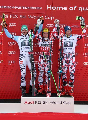 Felix Neureuther of Germany (2nd place, L-R) Marcel Hirscher (1st place) and Benjamin Raich (3rd place) of Austria celebrate at the Men\