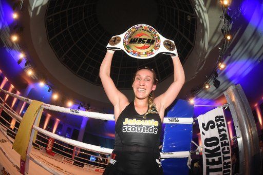 German kickboxer Julia Irmen rejoices over her victory after the fight for the WKU World Championship in kickboxing against Mellony Geugjes of the Netherlands at Stekos Fight Night in the Postpalast in Munich, Germany, 12 March 2015. Photo: FELIX ...