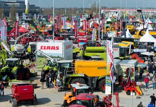 Agricultural vehicles are parked in the outdoor area of the agricultural trade fair \