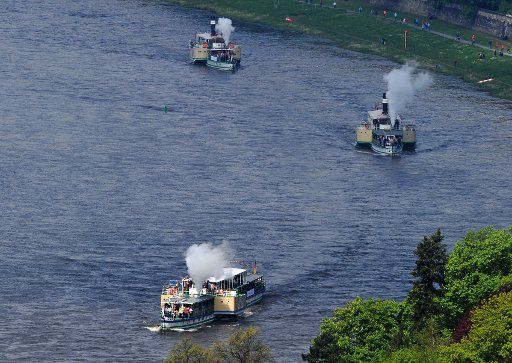 The historic steamboats of the Saxon Steam Navigation Fleet take off for the traditional fleet review on the Elbe River in Dresden, Germany, 01 May 2015. They will go in formation to Pillnitz Castle and back. Photo: MATTHIAS HIEKEL\/