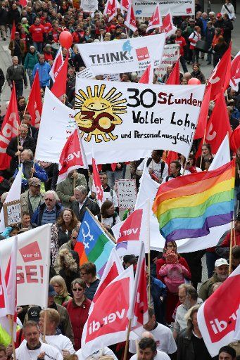 People rally with flags and banners during a demonstration organized by the Confederation of German Trade Unions (DGB) on May Day in Hamburg, Germany, 01 May 2015. This year\