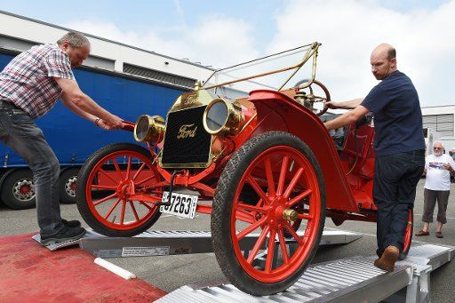 Hannes Steim (R) of the Steim Car Collection in Schramberg and an employee move a Ford T, also called Tin Lizzie, to the exhibition hall a day prior to the opening of the vintage car fair \