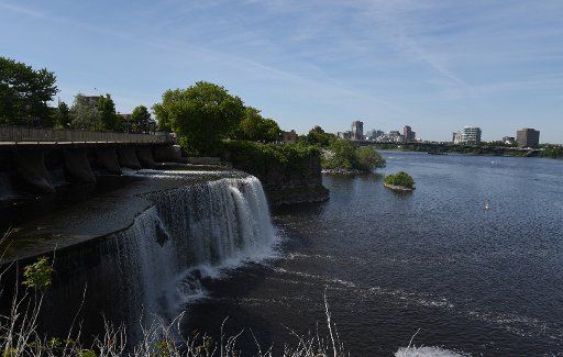 Water runs from a barrage into the Ottawa River in Ottawa, Canada, 15 June 2015. The Ottawa skyline can be seen in the background. Photo: CARMEN JASPERSEN\/