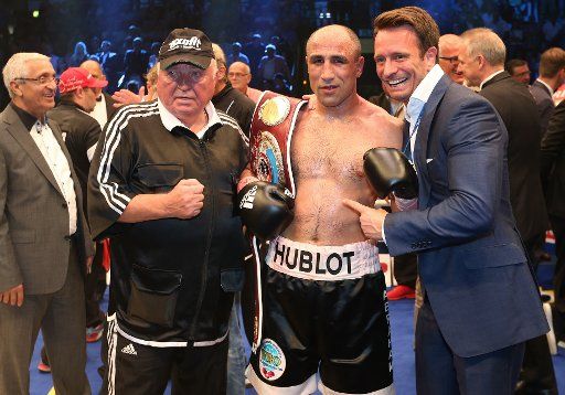 WBO Boxing World Cup - Super middle weight fight: Abraham vs. Stieglitz both from Germany fight in the Gerry-Weber-Stadion in Halle, Germany, 18 July 2015. Arthur Abraham (L) celebrates after his win with coach Ulli Wegner (l) and promoter Kalle ...