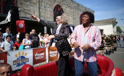 The pop singer Roberto Blanco (r) with the President of the Jury Irmgard Knueppel in the Handbag Throwing World Championship taking place in Bottrop, Germany, 1 August 2015. Photo: OLIVER BERG\/