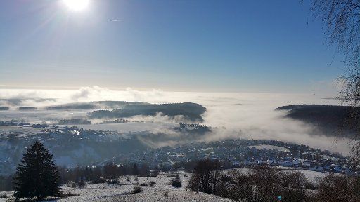 A valley shrouded in fog surrounding the small town Rauenstein, Germany, 27 November 2015. Photo: STEFAN THOMAS\/