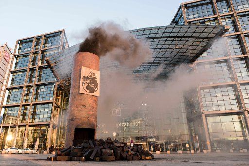 An imitation industrial chimney billows smoke at a protest themed "Frau Hendricks, verkohlen Sie uns nicht", calling for German Environment Minister Hendricks to avoid coal, outside the main railway station in Berlin, Germany, 28 November 2015. The ...