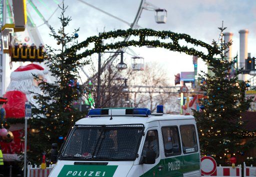 A police car stands between two Christmas trees during the opening of the Christmas market at the Alexa shopping center in Berlin, Germany, 23 November 2015. Photo: Soeren Stache\/