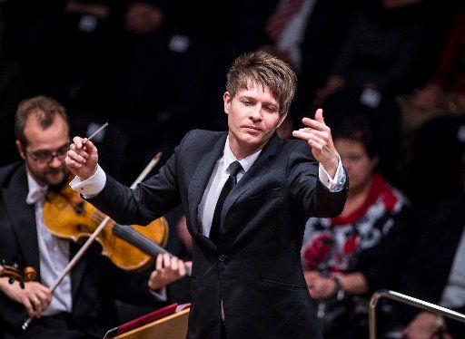 Polish conductor Krzysztof Urbanski conducts the NDR symphony orchestra at the Music and Congress Hall in Luebeck, Germany, 11 December 2015. Photo: OLAF MALZAHN\/