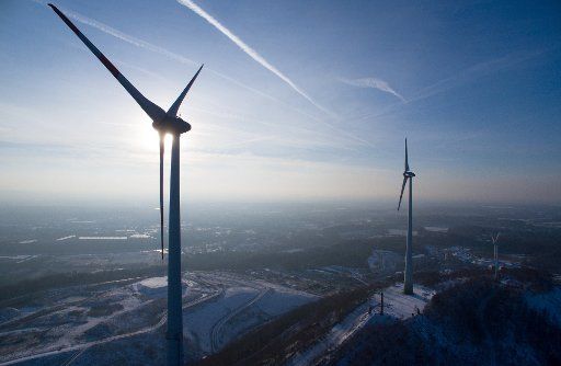 Wind turbines spin in the wind on the peak of the Piesberg mountain near Osnabrueck, Germany, 18 January 2016. Photo: Friso Gentsch\/dpa (EDITORIAL NOTE: Picture taken with airborne drone)