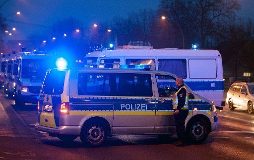 A police vehicle is parked on the intersection of Landsberger Allee and Rhin-Strasse in Berlin, Germany, 02 March 2016. There was a police operation there, during which a suspect was killed. Photo: PAUL ZINKEN\/