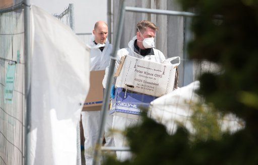 Police officers carry boxes out of the house of the incriminated couple in Hoexter-Bosseborn, Germany, 04 May 2016. A couple from Hoexten allegedly viciously abused multiple women at the homestead - at least two victims died. Photo: FRISO GENTSCH\/...