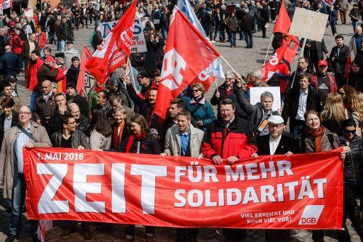 Katja Karger (3-L, carrying banner), chairwoman of the Confederation of German Trade Unions (DGB) in Hamburg, Berthold Bose (4-L), chairman of German trade union Verdi in Hamburg, and Annelie Buntenbach (R) carry a banner that reads \