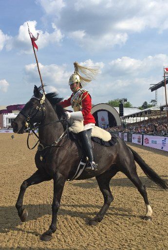 A guardsman rides during the CHI Royal Windsor Horse Show in Windsor, Great Britain, 12 May 2016. This year the annual horse show is taking place within the scope of celebrations for the Queen\