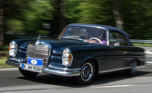 Participants of an Oldtimer tour drive a historic car near Niedergladbach, Germany, 27 May 2016. The serpentine roads of the Rheingau region are popular also among motorcyclists. Photo: Boris Roessler\/