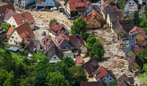 Debris piles up in a residential street in Braunsbach, Germany, 30 May 2016. Parts of Southern Germany have been flooded after heavy thunderstorms. Photo: Christoph Schmidt\/