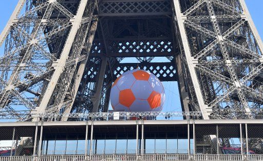 A large ball sits in the Eiffel tower in Paris, June 8, 2016. The UEFA EURO 2016 soccer championship takes place from 10 June to 10 July 2016 in France. Photo: Peter Kneffel\/