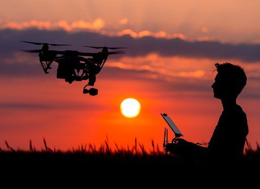 ILLUSTRATION - A boy controlling a Quadrocopter drone of the type DJI Inspire 1 in front of the sundown in Sieversdorf, Germany, 8 June 2016. PHOTO: PATRICK PLEUL\/