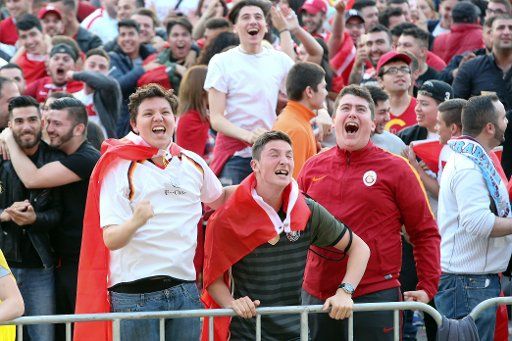 Fans celebrate the 0:1 goal for Turkey in the match Turkey vs Czech Republic at a public screening event at Heiligengeistfeld in Hamburg, Germany, 21 June 2016. Photo: Bodo Marks\/
