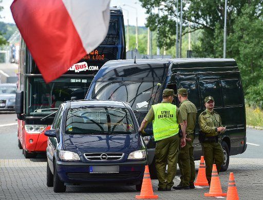 Polish border guards check vehicles at the A12 motorway border crossing from Germany to Poland, in Swiecko, Poland, 4 July 2016. Poland has reinstated spot border checks until 2 August, ahead of the Nato summit and papal visit. PHOTO: PATRICK PLEUL\/...