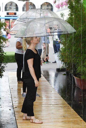 Model Louisa looking at the interactive sound installation RainDance by US artist Paul De Marinis at the Marktplatz in Karlsruhe, Germany, 21 July 2016. The artwork is part of the Digitale Wasserspiele 2016 (lit. digital water games 2016 which run ...