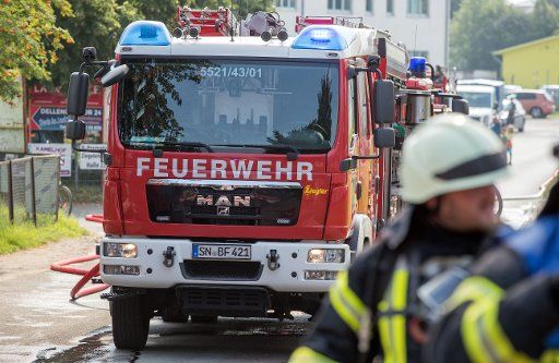 Figherfighters put out a fire in a sports facility in Schwerin, Germany, 25 July 2016. Reasons for the fire are still unknown. According to initial knowledge, no one was injured. Photo: Jens Buettner\/