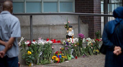 The figure of a weeping rabbit stands next to flowers and candles in front of the entrance of Paula Fuerst school in Berlin, Germany, 17 July 2016. Two students and a teacher from the school are missing after the terrorist attack in Nice. Photo: ...