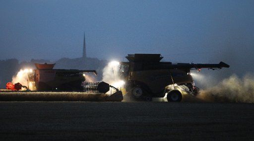 Harvesters at work on a grain field located north of Leipzig, Germany, 20 July 2016. Photo: Sebastian Willnow\/