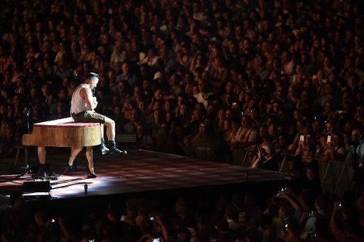 The crowd in the stadium listen as Austrian singer Andreas Gabalier speaks before his show at Olympiastadion where he is giving a concert in Munich, Germany, 30 July 2016. Photo: Felix Hoerhager\/