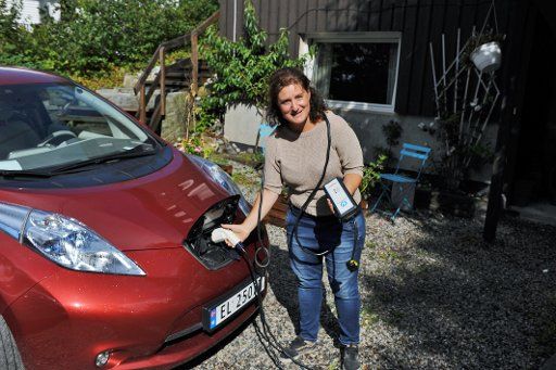 Louise Brunborg-Næss from fills up her electric Nissan in Son-Olso, Norway, 05 August 2016. Photo: SIGRID HARMS\/