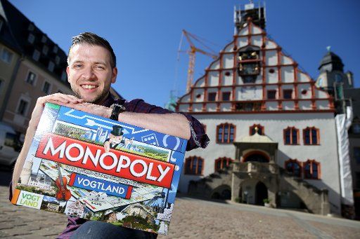 Initiator Florian Freitag pictured with the Vogtland edition Monopoly set at the market square in Plauen, Germany, 31 August 2016. The game features 22 locations from the region. In Germany, there are more than 150 regional editions. PHOTO: JAN ...