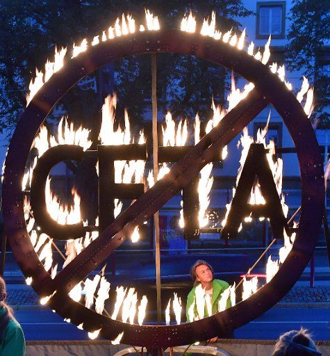 Greenpeace activists protesting with a burning CETA symbol in front of the state parliament of Thuringia in Erfurt, Germany, 7 September 2016. Greenpeace asks the Prime Minister of Thuringia to speak out against the preliminary application of the ...