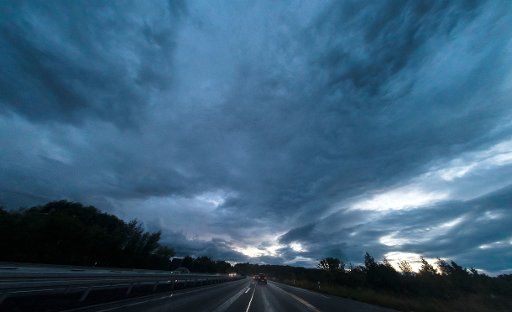 Dark rainclouds can be seen in the sky above highway A2 near Braunschweig, Germany, 02 October 2016. Photo: PETER STEFFEN\/