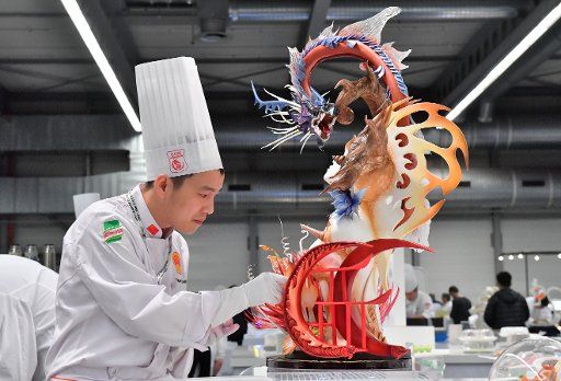 A chef of the Chinese national team works on their plate presentation at the international cooking olympia in Erfurt, Germany, 22 October 2016. The "Olympia of Chefs" has over 2000 participators from 59 countries, according to the German Association ...