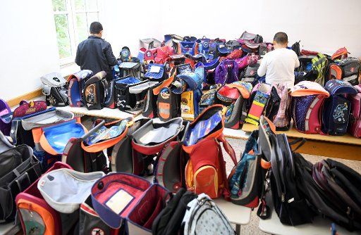 Donated backpacks seen in a room at \