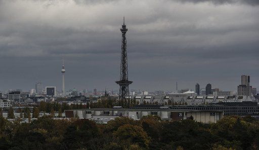 The radio tower and the TV tower loom in the cloudy sky in Berlin, Germany, 02 November 2016. Photo: PAUL ZINKEN\/