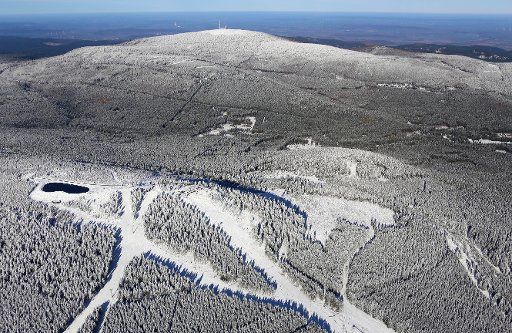 The skiing tracks are covered in snow on Wurmberg mountain, Germany, 14 November 2016. The highest mountain of the Harz region, the Brocken, can be seen in the back. PHOTO: STEFAN RAMPFEL\/