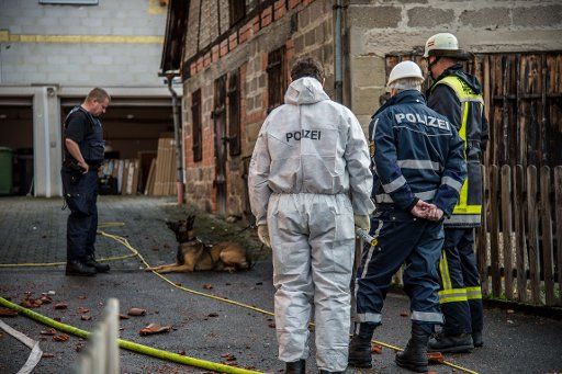 Firefighters and police officers secure the site of a fire in Pfedelbach, Germany, 17 November 2016. According to police statements there are indicators that the fire was the result of arson. Photo: Sven Friebe\/