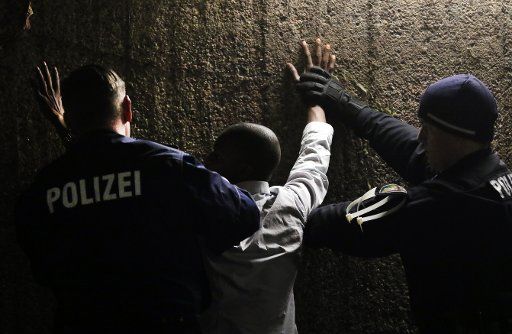 Police officers search a man for drugs at the Ebertplatz underground station in Cologne, Germany, 16 December 2016. The city and police have worked out a comprehensive security concept for New Year\