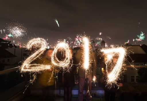 People lighting fireworks celebrate the New Year in Bielefeld, Germany, 01 January 2017. Photo: Friso Gentsch\/