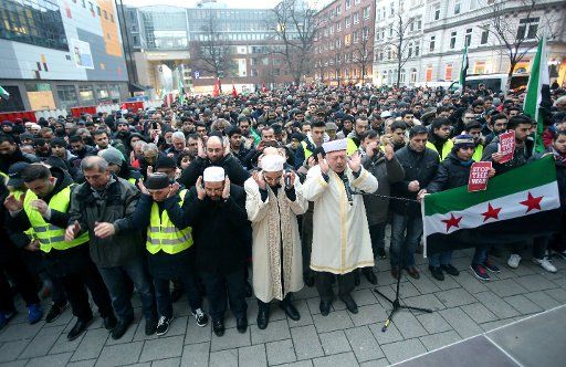 Demonstrators pray at a protest called Stand up for Aleppo in the city centre of Hamburg, Germany, 17 December 2017. Hundreds of people protested against the war in Syria Photo: Bodo Marks\/