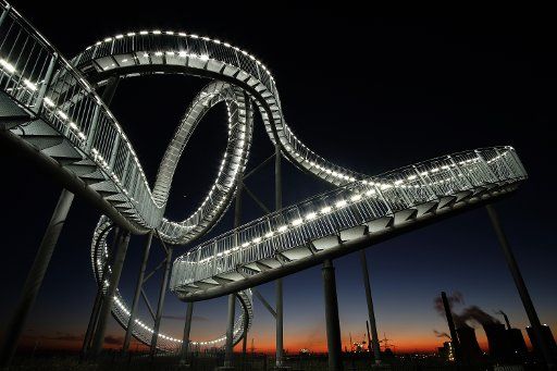 The sun sets behind the sculpture Tiger and Turtle - Magic Mountain in Duisburg, Germany, 19 Janaury 2017. Photo: Kevin Kurek\/