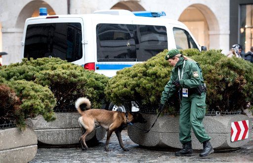 A officer with a sniffer dog outside the Bayerischer Hof hotel which will host the Munich Security Conference in Munich, Germany, 17 February 2017. Photo: Sven Hoppe\/