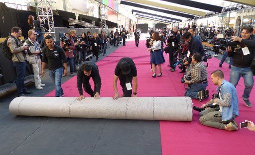 Men are rolling out the red carpet in preparations for the Oscars ceremony in Los Angeles, USA, 22 February 2017. Dozens of camera teams and photographers have followed the \
