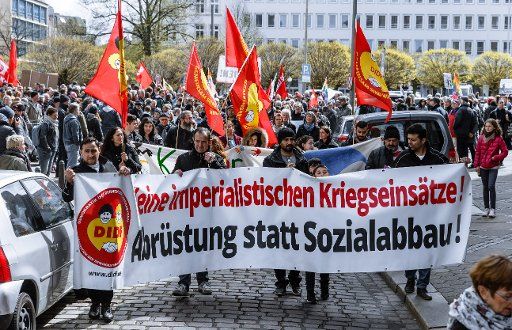Demonstrators carry a banner with the inscription "No imperialist wars. Disarmament instead of cuts in social spending!" during this year\