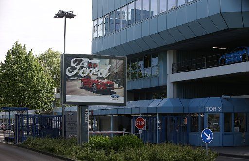 An advertising poster seen by the gate of a Ford plant in Cologne, Germany, 15 May 2017. Photo: Oliver Berg\/