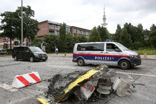 A police car from Austria, photographed during the clearing up in the Schanzenviertel district in Hamburg, Germany, 8 July 2017. Militant protesters left a path of destruction in the Sternschanze district in Hamburg. Photo: Bodo Marks\/