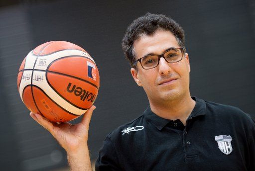 Hamburg Towers manager Hamed Attarbashi holds a basketball at a press conference in Hamburg, Germany, 1 August 2017. The German basketball team is preparing itself for the Pro A season. Photo: Daniel Reinhardt\/